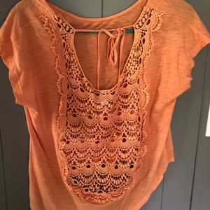 Cute orange top. High in front and long in back.